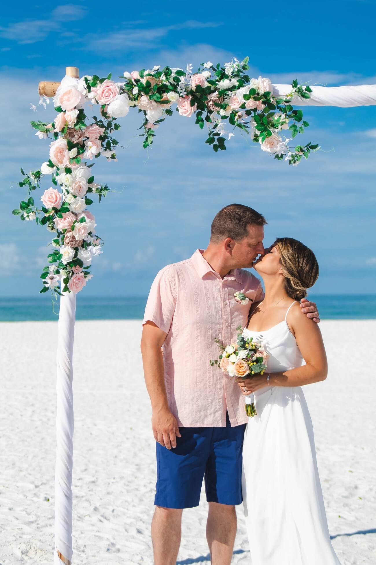 An elegant fresh-flower beach wedding moment on the Gulf Coast